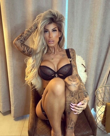 Gata glamourosa e sexy mostra suas tatuagens deslumbrantes em lingerie preta