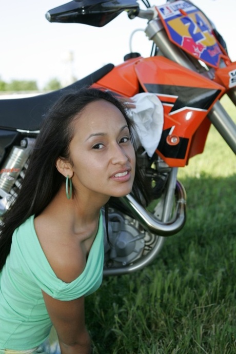 Breathtaking Latina Pamy posing for outdoors for a motorcycle magazine