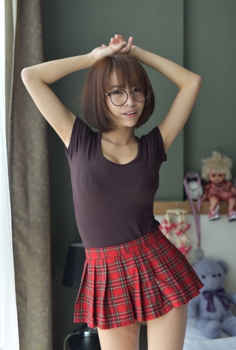 Pretty Asian teen flaunts her hot ass wearing a miniskirt and panties