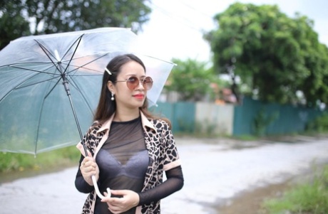 Asian seductress Jessica Phuong poses in her hot outfit with an umbrella