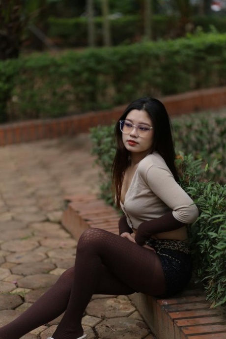 Brunette model with glasses Natalia posing in her provocative outfit outdoors