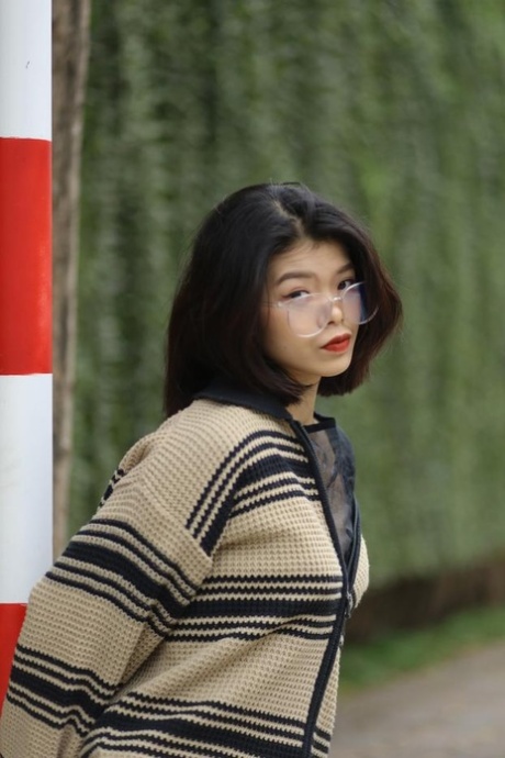 Gorgeous Asian doll with glasses Irena posing in her cute sweater outdoors