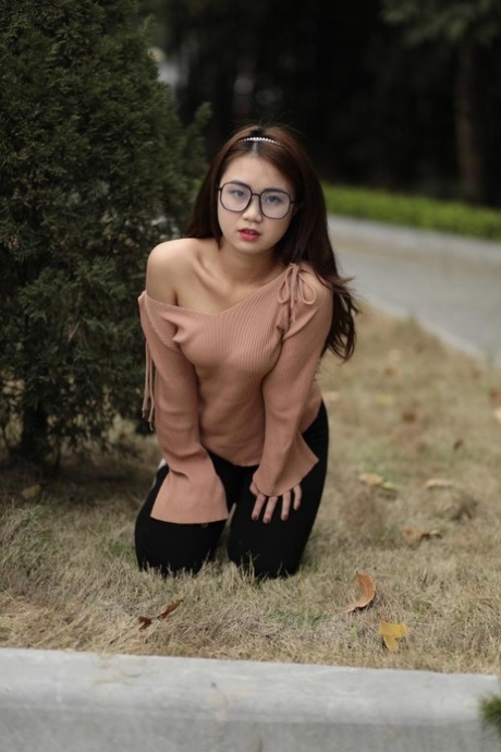 Pretty Asian babe with glasses Elena enjoys posing in her hot outfit outside