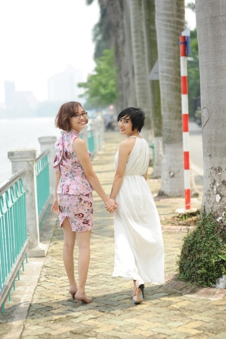 Short-haired Asian models posing in their summer dresses on the beach