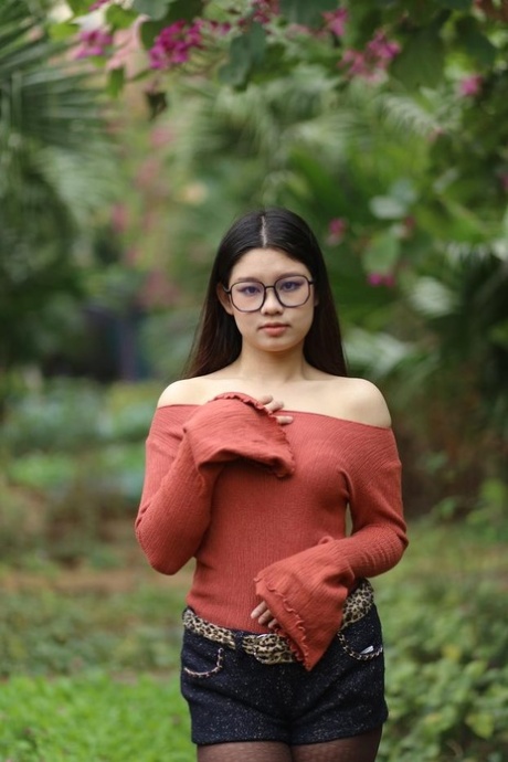 Glamorous Asian girl with glasses Natalia posing in her hot outfit outdoors