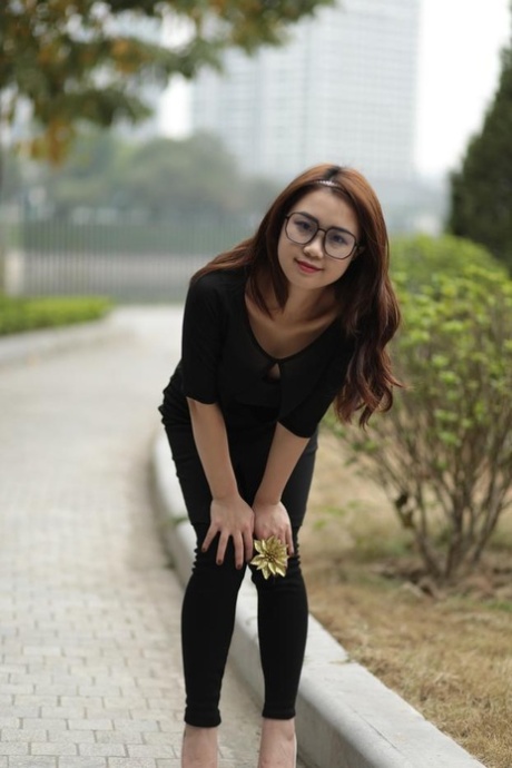 Redheaded Asian girl with glasses Elena posing in her black outfit in public