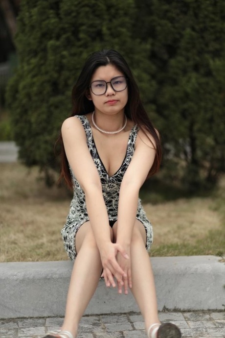 Small Asian babe with glasses posing in her lovely summer dress in public