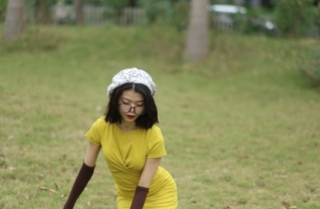 Tiny Asian babe with glasses & hat Irena posing in her tight yellow dress