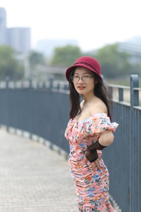 Cute Asian girl with glasses Natalia poses in her summer dress in public