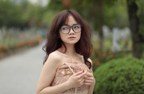 Tiny Asian babe with eyeglasses posing in her lovely summer dress in public