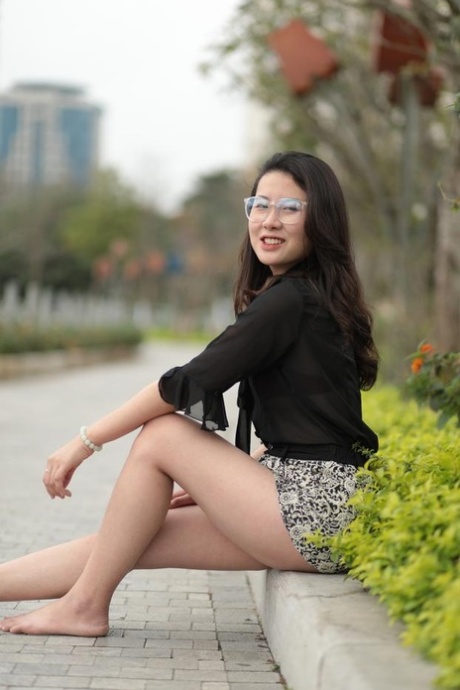 Nerdy Asian girl Elena posing in her cute blouse and skirt in public