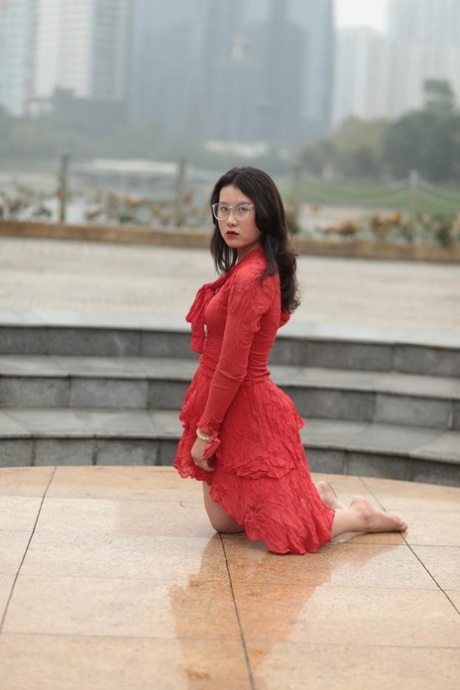 Glamorous Asian model with eyeglasses Elena posing in the rain in public