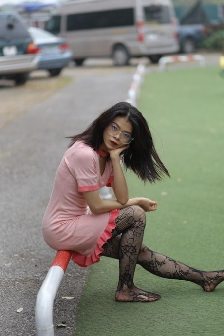 Gorgeous Asian babe Irena posing in her hot dress & stockings in public