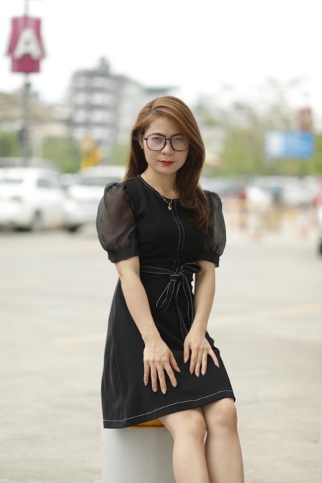 Tiny Asian babe with glasses posing in her black dress in public