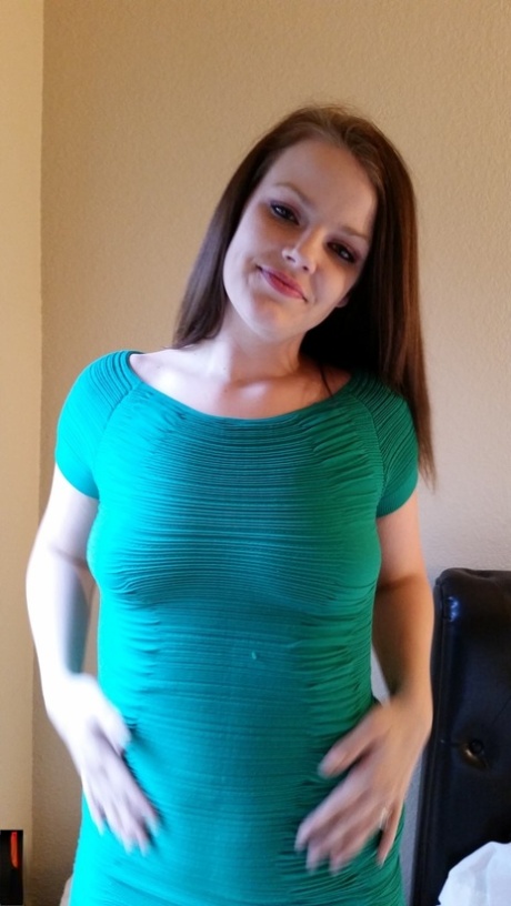 Luscious amateur babe posing in her tight turquoise dress in a solo