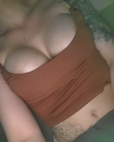 Beautiful inked babe teases with her cleavage & covered big boobs in selfies