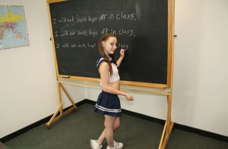 Little teen giving her tall blonde teacher a great handjob in the classroom