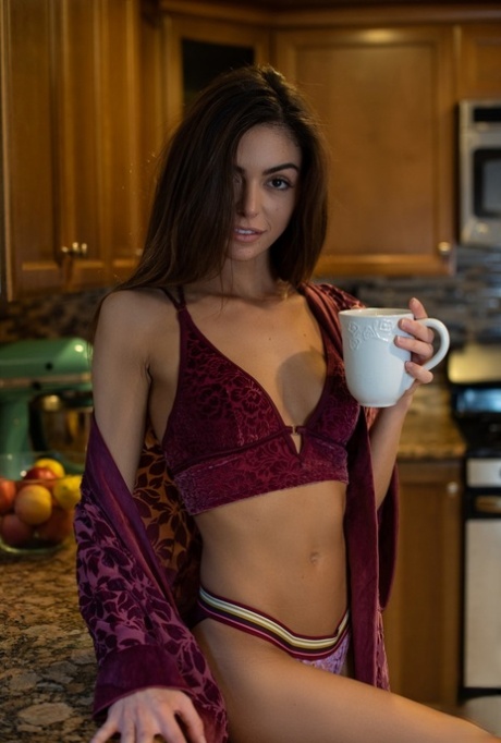 Alluring babe Olia Adams shows off her petite naked body in the kitchen