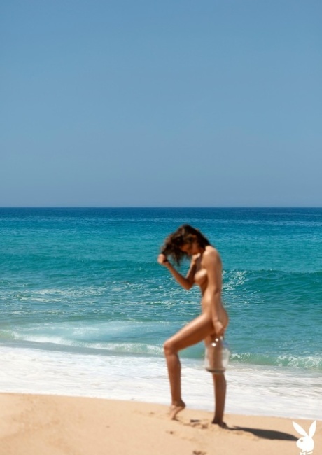 Emily Agnes, uma rapariga glamorosa, provoca com as suas mamas perfeitas na praia