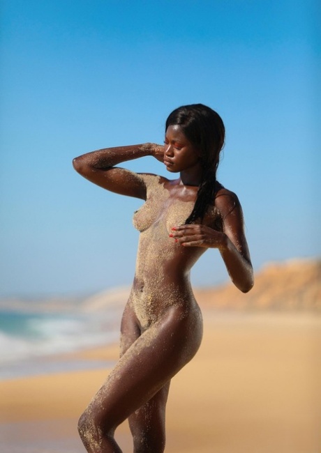 Glamorous French babe Naomi Nash exposes her sexy ebony curves on the beach