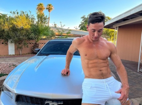 Shirtless gay shows off his muscles & his big dick while washing his car