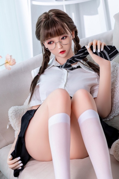 Pigtailed schoolgirl sex doll with glasses Cheryl stripping and posing naked
