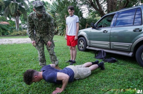 Gay boys have a wild anal threesome with a military man outdoors