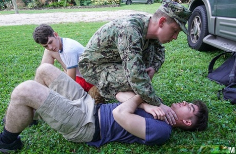 Gay boys have a wild anal threesome with a military man outdoors