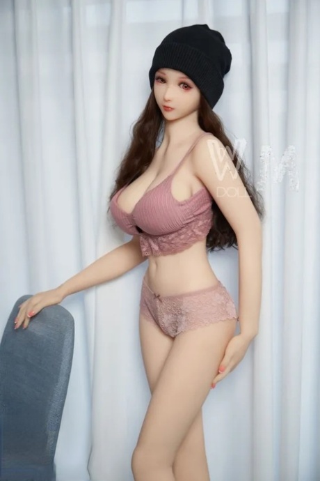 Beautiful sex doll with a hat strips her lingerie and poses naked