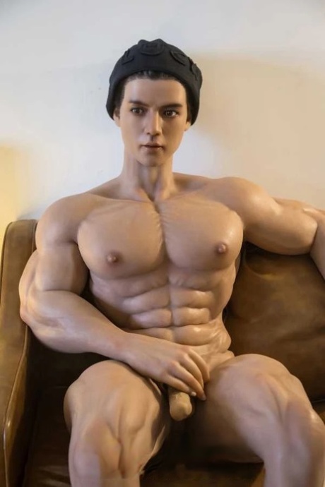 Realistic male sex doll shows off his muscular body while fully naked