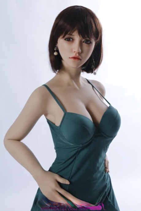 Beautiful lifelike sex doll shows her flawless body wearing a sexy dress