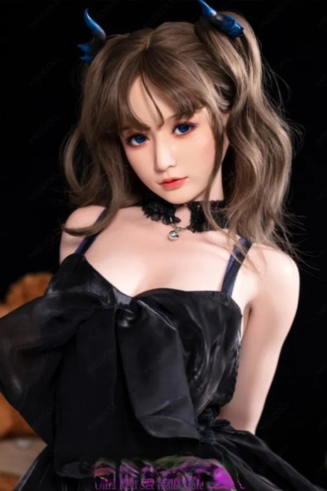 Pretty sex doll shows her big boobs wearing a beautiful black dress