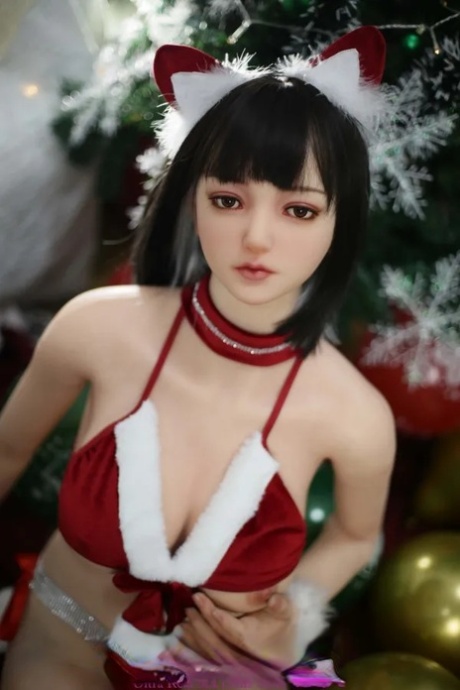 Dark-haired sex doll Kamiyah poses in her Christmas outfit & touches herself