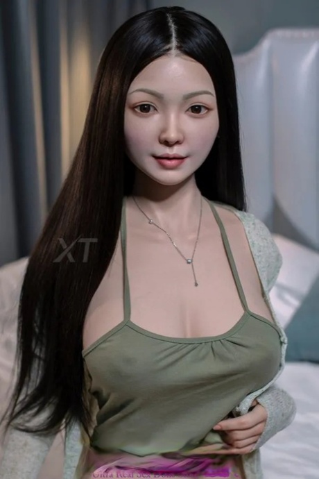 Silicone Asian sex doll shows off her juicy breasts and poses in her room