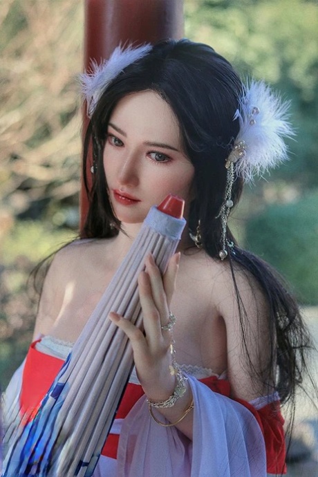 Brunette Asian sex doll Mifei poses in her traditional outfit & shows her tits