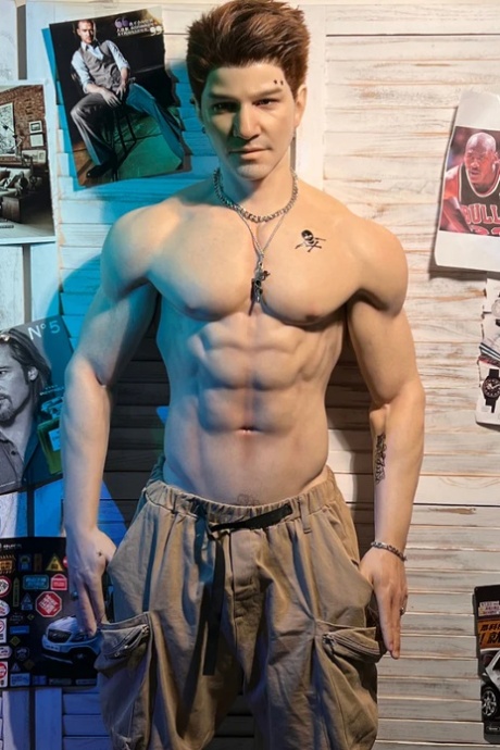 Saucy silicone male sex doll Herman exposes his muscles while posing topless