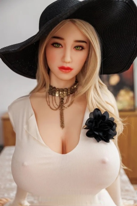 Stacked blonde sex doll shows off her curvy ass and her big boobs