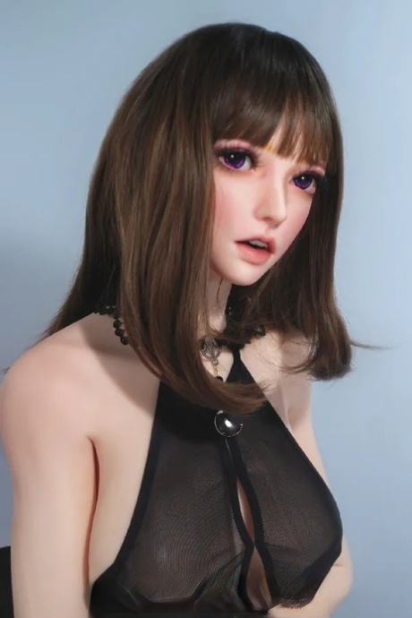 Dark-haired sex doll Kurai posing in her sexy black dress in a solo