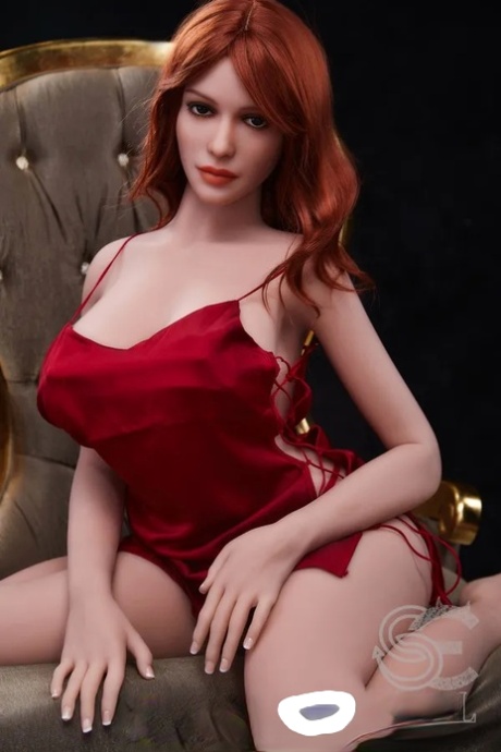 Glamorous redheaded sex doll Madeline undresses & shows her curvy body