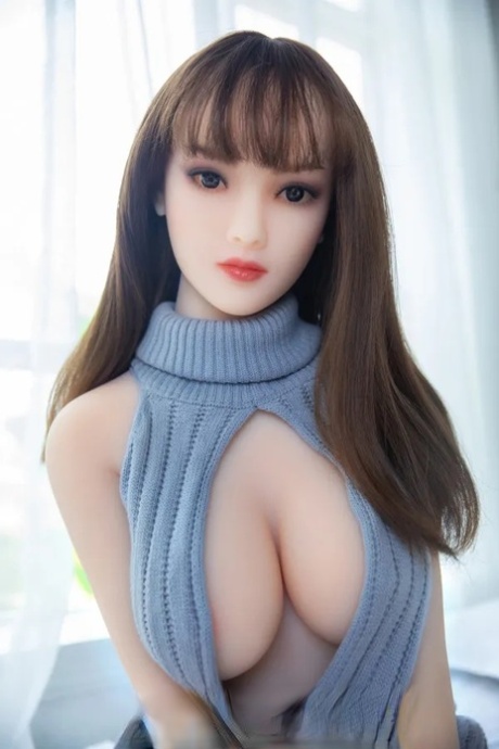 Pretty petite sex doll shows off her big boobs and her curvy ass