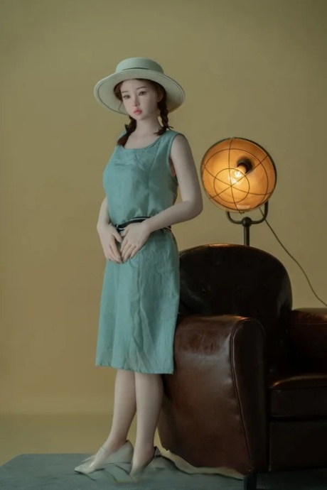 Female sex doll dons a dress and hat before returning to her naked state