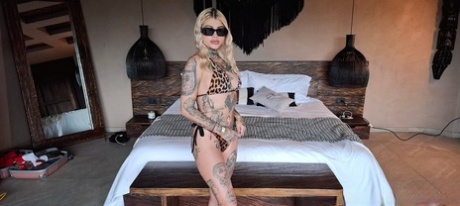 Slim inked pornstasr Blondie Cat shows her breasts and ass and poses