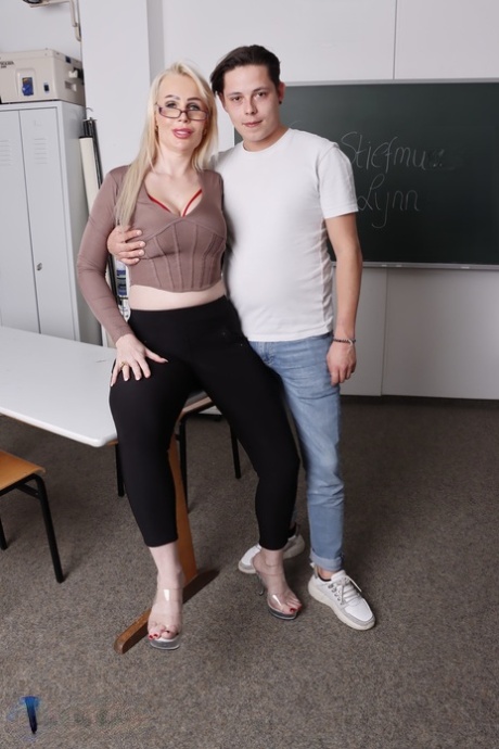 Blonde teacher with glasses Lynn seduces and screws her handsome student