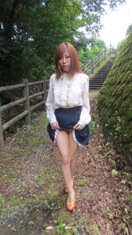 Petite Asian nympho Chihiro Akino flashes her cunt and gives head outdoors