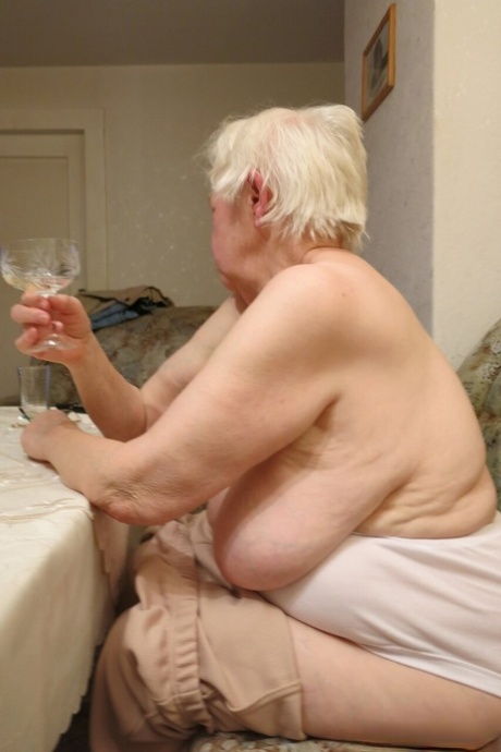 Kinky blonde granny Zizoresta poses naked and teases with her huge tits