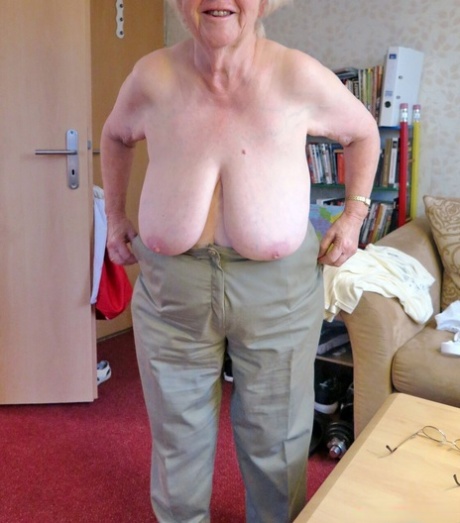 Kinky blonde granny Zizoresta poses naked and teases with her huge tits