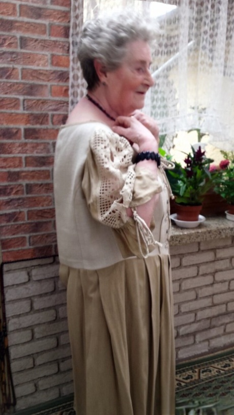 Short-haired granny Pitschka undressing and showing her saggy boobs