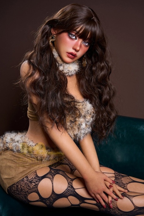 Caucasian sex doll with striking eyes sports a tail butt plug while going nude