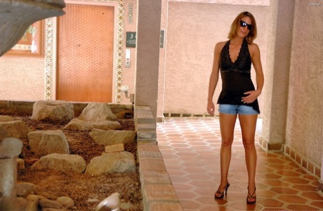 Skinny teen Jolene shows her small tits and flaunts her hot legs outdoors