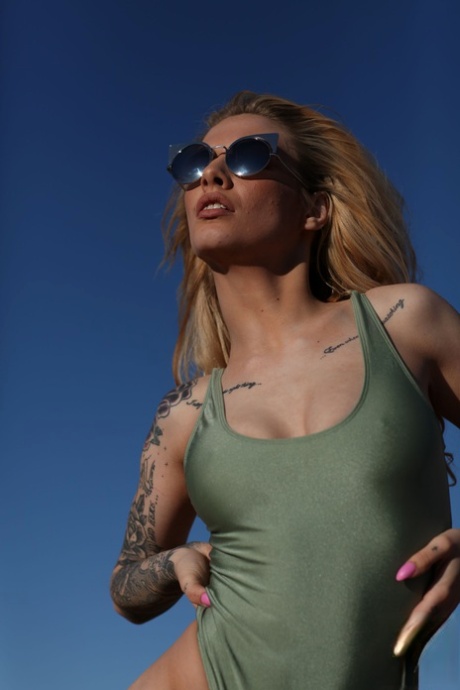 Blonde model with tattoos Saskia Valentine shows her fine breasts outdoors
